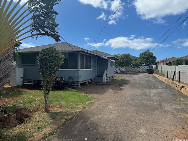 91-507 Ewa Beach Rd, Ewa Beach, HI 96706 - view of home's exterior featuring asphalt driveway and roof with shingles