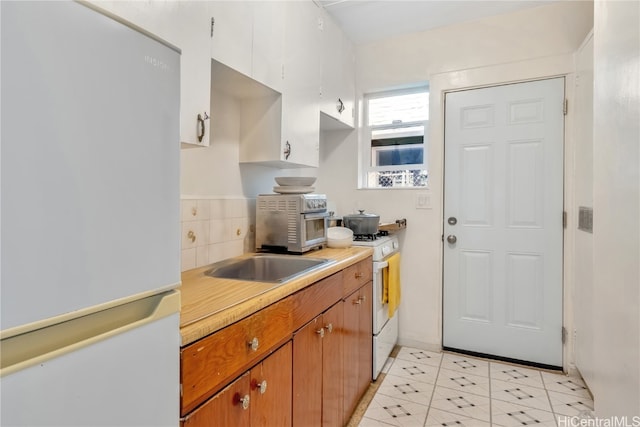 kitchen with white appliances and light tile patterned floors