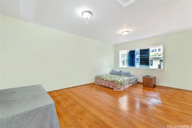 bedroom with hardwood / wood-style flooring