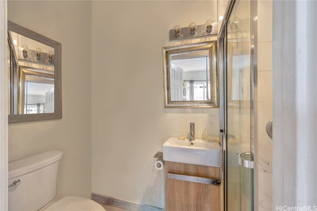 bathroom with vanity, toilet, and an enclosed shower