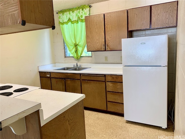 kitchen with white fridge and sink