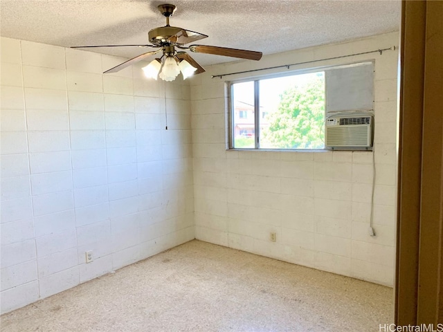 carpeted spare room featuring a textured ceiling, ceiling fan, and cooling unit