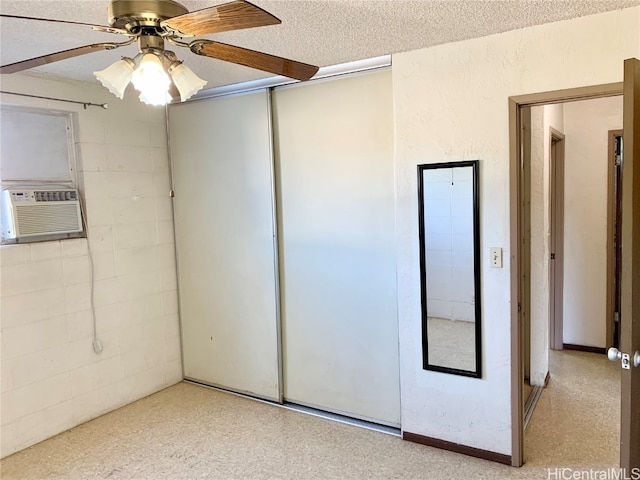 unfurnished bedroom with ceiling fan, a closet, cooling unit, and a textured ceiling