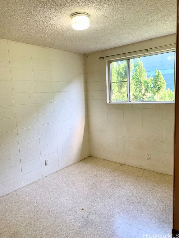 spare room featuring a textured ceiling