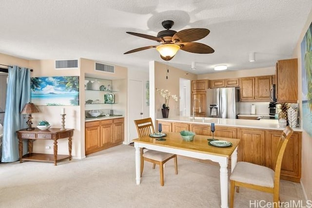 kitchen with light countertops, appliances with stainless steel finishes, and visible vents