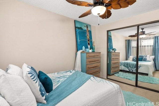 bedroom featuring a textured ceiling, a closet, and a ceiling fan