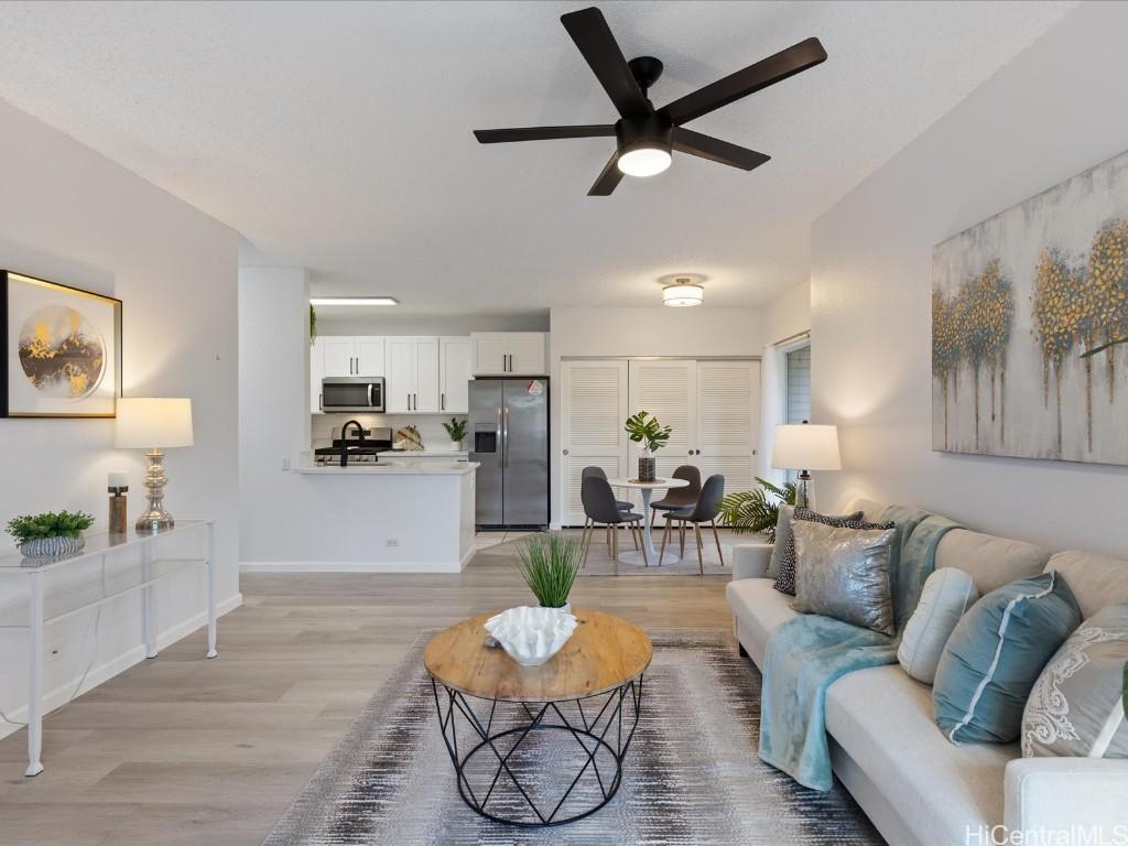 living room with light wood-type flooring and ceiling fan