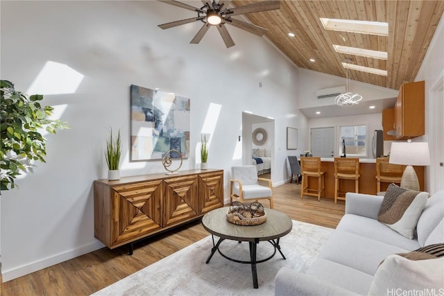 living room with a skylight, wood ceiling, ceiling fan with notable chandelier, high vaulted ceiling, and an AC wall unit