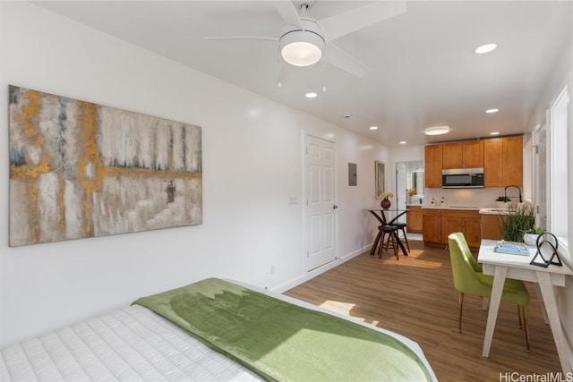 bedroom featuring hardwood / wood-style floors and sink