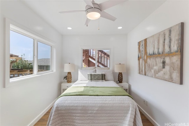 bedroom with wood-type flooring and ceiling fan