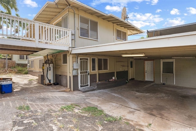 view of front of house with a wooden deck and water heater