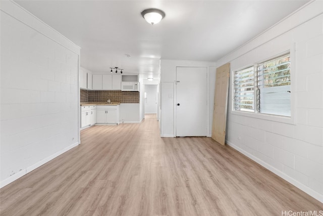unfurnished living room featuring light wood-type flooring