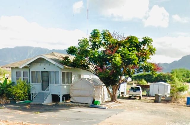 exterior space featuring a mountain view and a storage shed