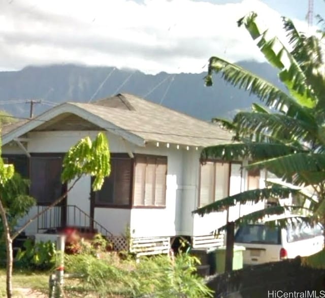 view of property exterior with a mountain view