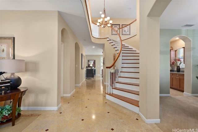 foyer entrance with a chandelier