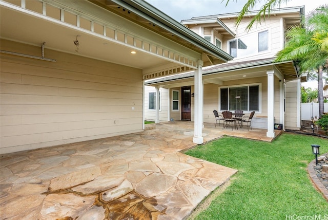 exterior space featuring a patio area and a lawn