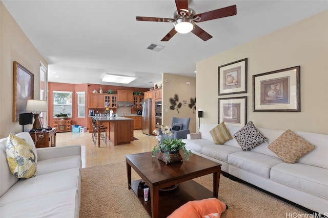 living room featuring ceiling fan and light tile patterned floors