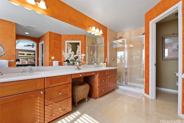 bathroom featuring tile patterned flooring, vanity, and a shower with shower door