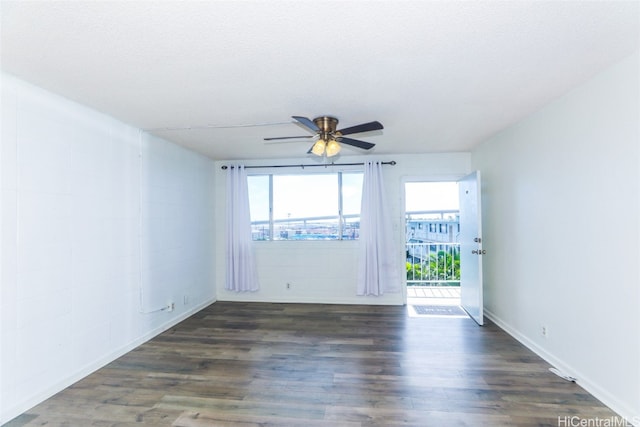 unfurnished room featuring a textured ceiling, ceiling fan, and dark wood-type flooring