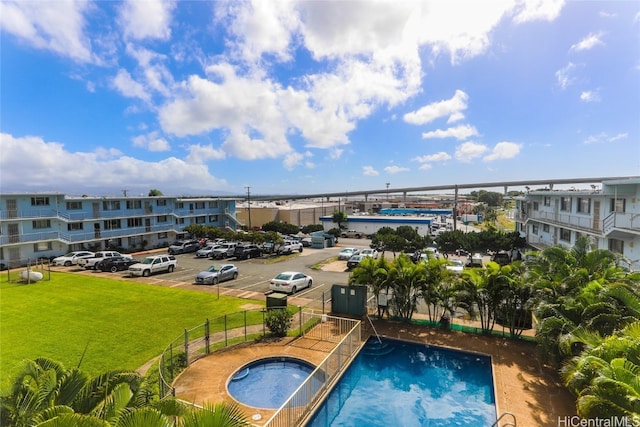 view of pool with a yard