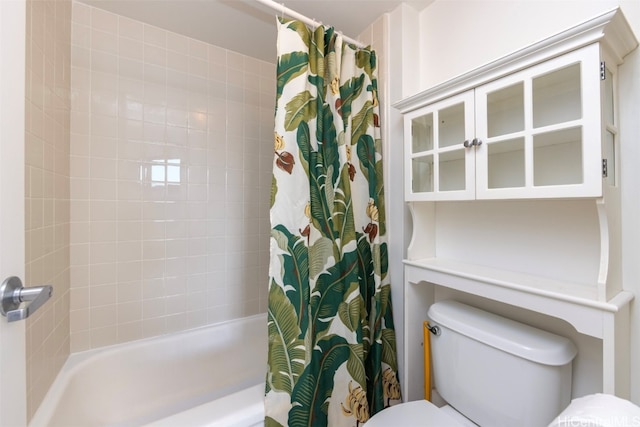 bathroom with toilet and shower / tub combo with curtain