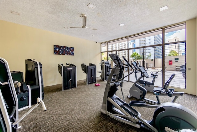 workout area with carpet flooring, a textured ceiling, a wealth of natural light, and ceiling fan