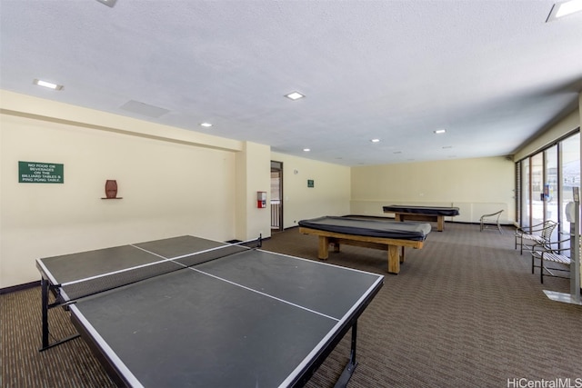 rec room featuring dark carpet, a textured ceiling, and pool table