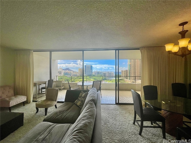 carpeted living room with expansive windows, a textured ceiling, and an inviting chandelier