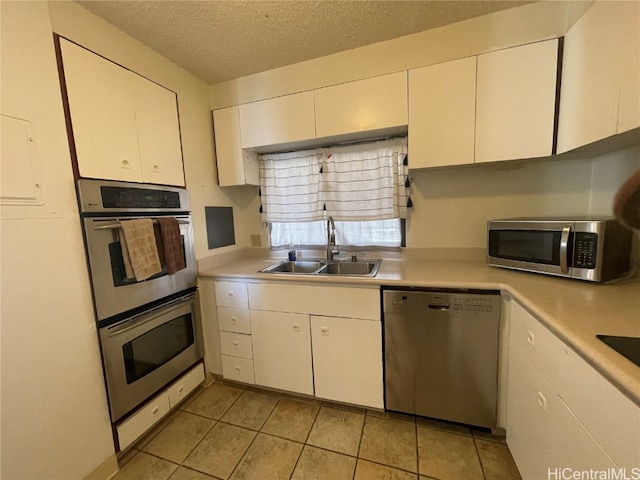 kitchen featuring white cabinetry, sink, and stainless steel appliances