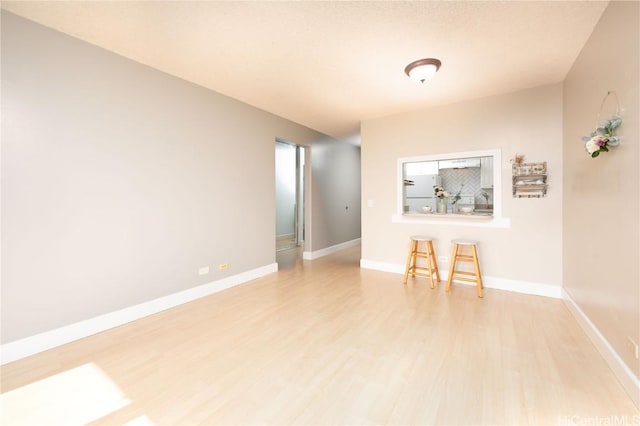 empty room with light hardwood / wood-style flooring