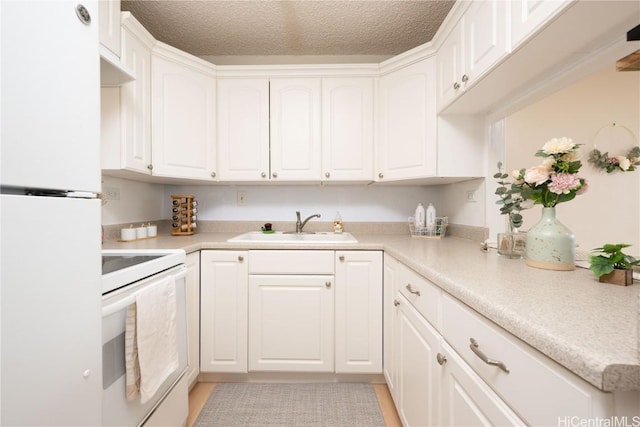 kitchen with white appliances and white cabinetry