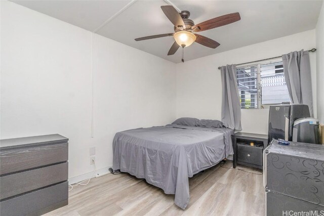 bedroom with light wood finished floors and a ceiling fan