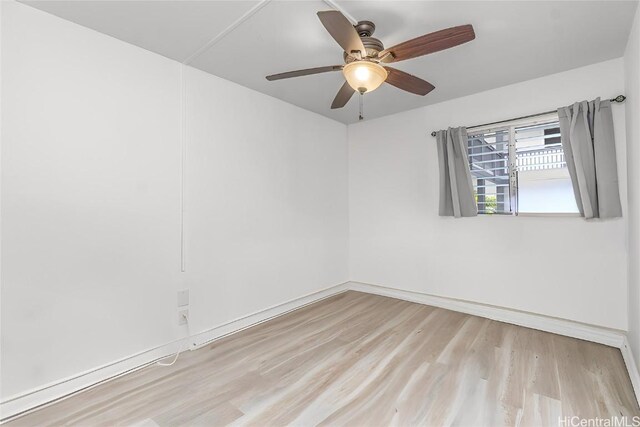 unfurnished room featuring ceiling fan, baseboards, and wood finished floors