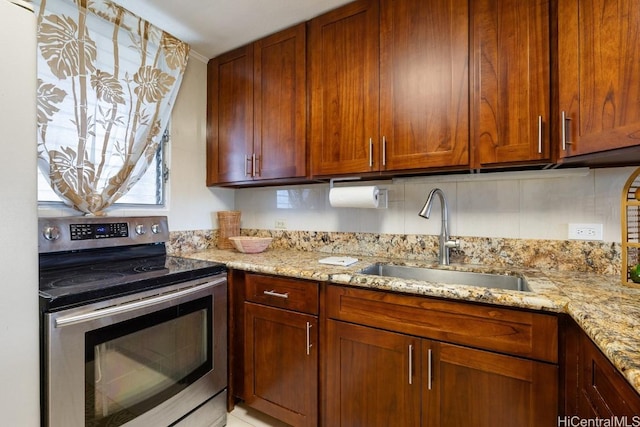 kitchen featuring light stone countertops, sink, tasteful backsplash, and electric stove