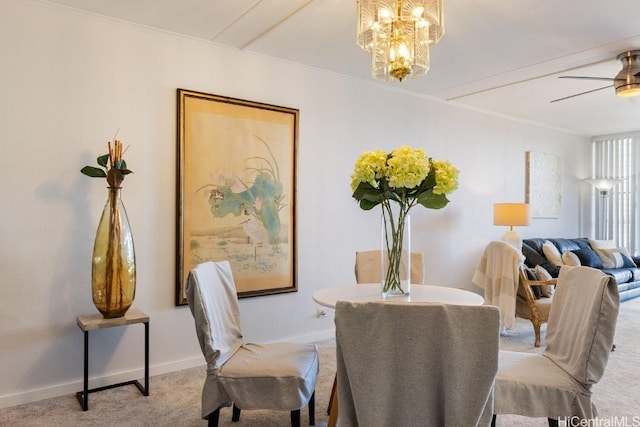 dining space featuring crown molding, light colored carpet, and ceiling fan with notable chandelier