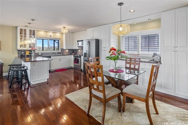 dining room featuring dark hardwood / wood-style floors and sink