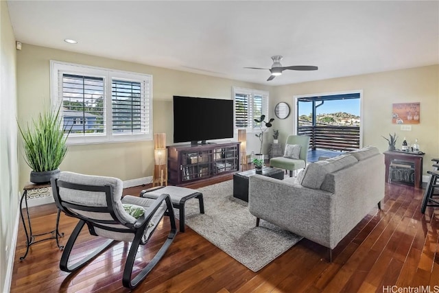 living room featuring ceiling fan, a healthy amount of sunlight, and dark hardwood / wood-style flooring