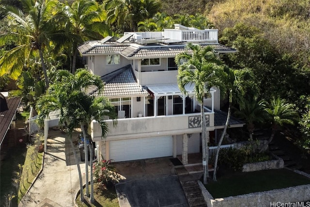 view of front of property with a garage and a balcony