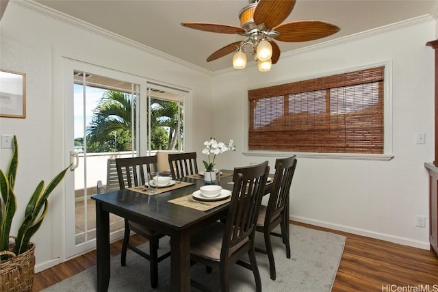 dining space with ornamental molding, ceiling fan, and dark hardwood / wood-style flooring