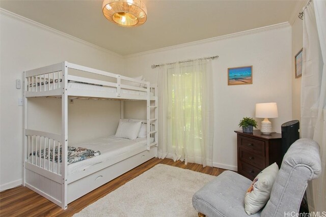 bedroom with ornamental molding and hardwood / wood-style floors