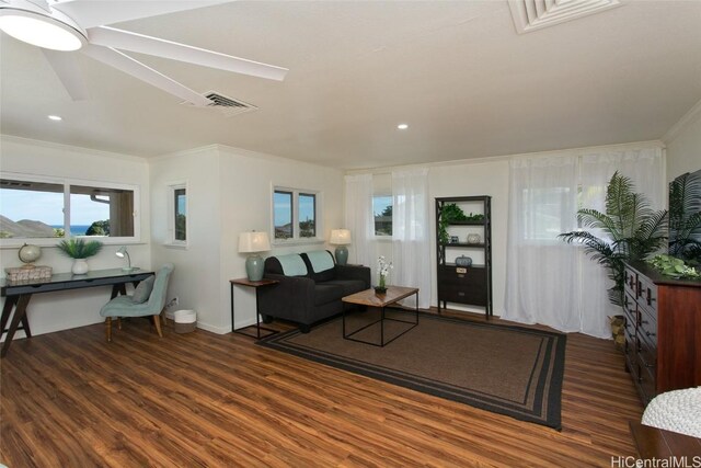 living room with crown molding and dark hardwood / wood-style floors