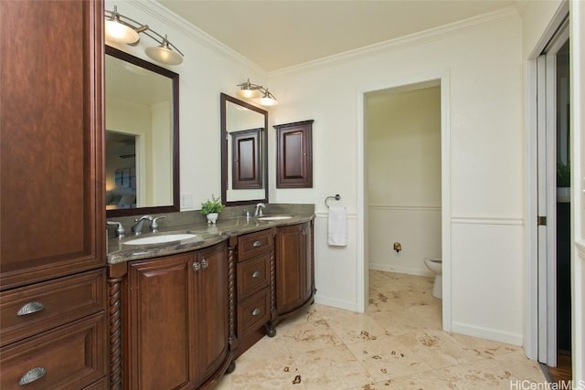 bathroom featuring vanity, ornamental molding, and toilet