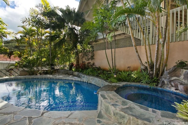 view of pool with an in ground hot tub