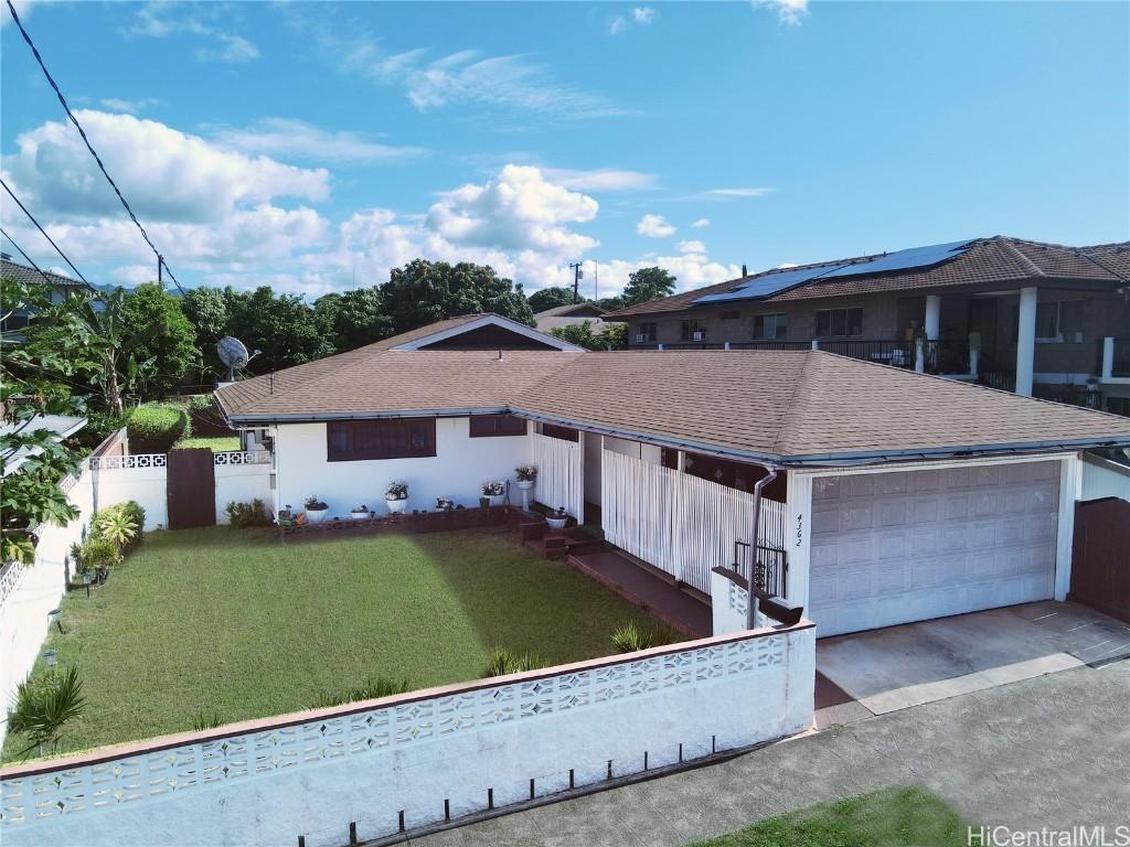 view of front facade with a front yard and a garage