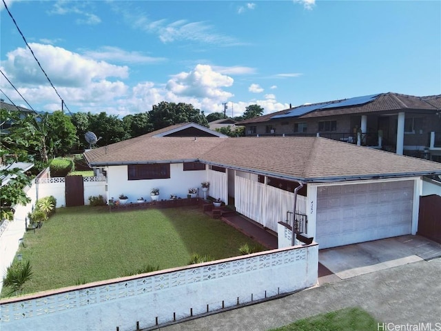 view of front facade with a front yard and a garage