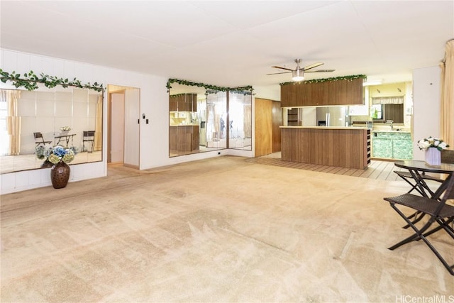 living room featuring ceiling fan and light colored carpet