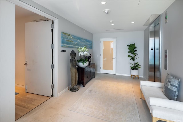 hall featuring recessed lighting and baseboards
