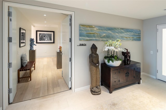 hall featuring recessed lighting and baseboards
