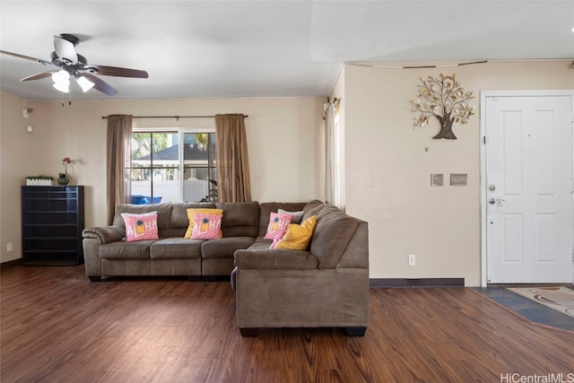 living room with dark hardwood / wood-style flooring and ceiling fan