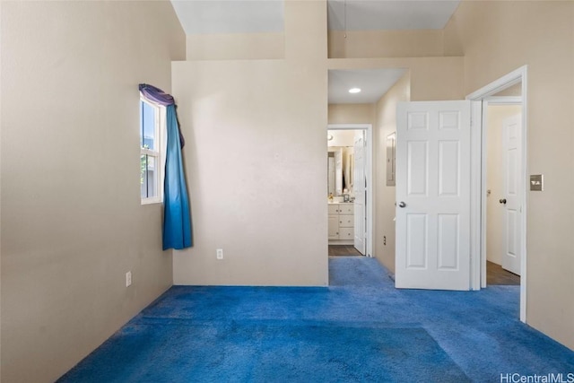 carpeted bedroom featuring connected bathroom